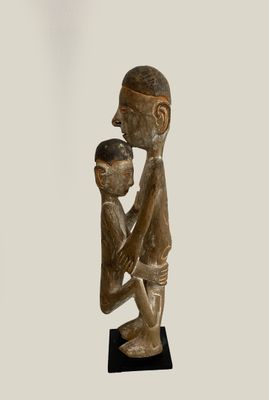 an image of a statue of a man holding a child