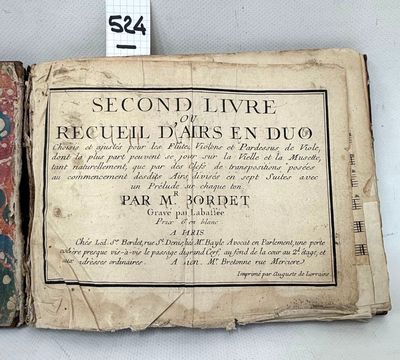 an old book with a picture of a woman on it