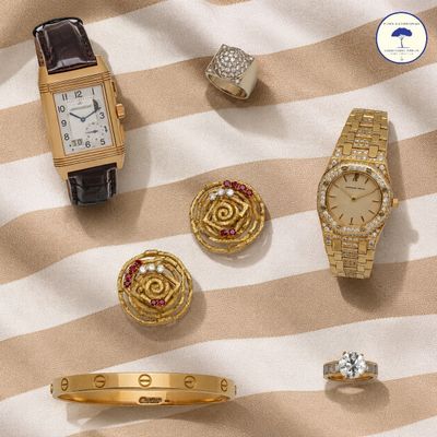 an assortment of gold and silver jewelry including a watch, bracelets, rings, and rings