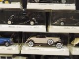 many different model cars on display in a display case