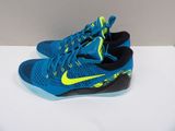 a pair of blue and yellow shoes on a white surface