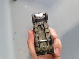 a person holding a toy car in their hand
