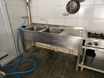 a kitchen with a sink and a stove in it