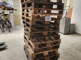 a stack of wooden pallets sitting in a room