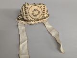 a small hat with a ribbon around it on a table