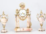 three different types of clocks and vases sitting on a table