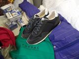 a pair of shoes sitting on top of a pile of luggage