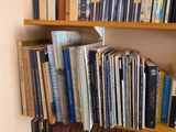 a bookshelf with many books on it in the corner of the room