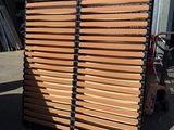 wooden slats stacked on top of each other in front of a building