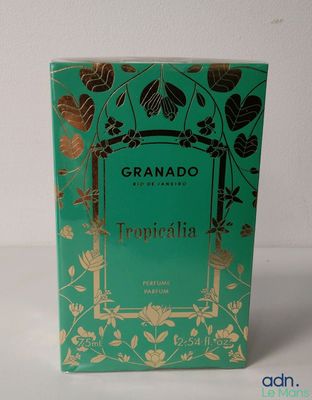 a green box with gold foil on it sitting on a table