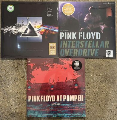 two pink floyd cds are sitting on the floor next to each other