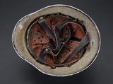 an old helmet with a leather band and a metal buckle on the side