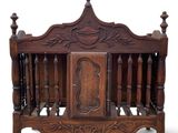 a wooden bed with a carved headboard and foot board