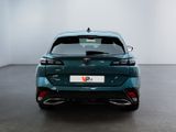 the rear end of a green car in a white room
