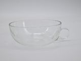 a glass cup that is sitting on a table
