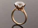 a close up of a diamond ring on a reflective surface