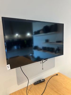 a flat screen tv mounted on a wall in a room