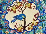 a blue bird sitting on a branch of a tree surrounded by flowers