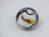 a marble that is sitting on a white surface