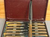 a box with a knife and six knives in it