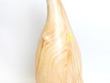 a wooden vase that has a yellow sticker on it
