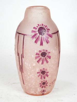 a pink vase with purple flowers on it on a white surface