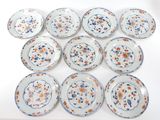 six plates with orange and blue designs on them on a white surface