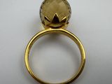 an image of a gold ring with a large faceted smoky quartz stone
