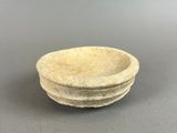 a close up of a bowl on a table with a gray background