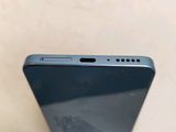 the back of a black cell phone sitting on top of a table