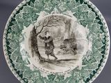 an image of a plate with a picture of a boy and a dog on it