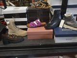several pairs of shoes are sitting on a shelf in a shoe store