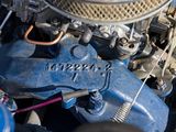 a close up of a car engine with a blue carbuke