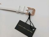 a close up of a white watch with a tag on it