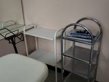 a small table with a mirror and a bed in a room