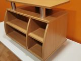 a wooden desk with a shelf on it in front of an orange wall