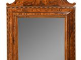 un vieux miroir en bois avec un cadre sculpté sur fond blanc