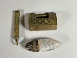a small metal object next to a small metal object