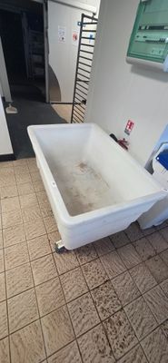 a bathtub in the middle of a tiled floor in a bathroom