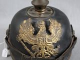 a black helmet with a gold eagle on it