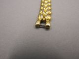 an image of a gold bracelet on a table