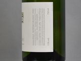 a bottle of wine sitting on a table with a label on it