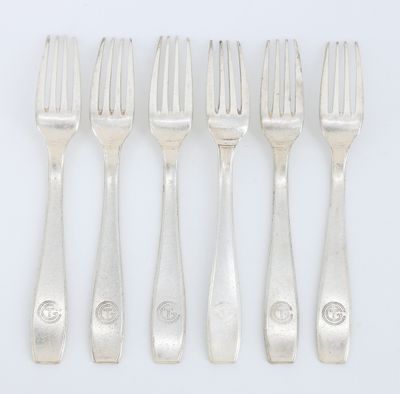a set of six forks and a knife on a white surface