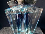 a glass vase that has a blue liquid inside of it