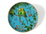 two birds sitting on a branch of a tree on a plate