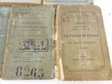 several old books sitting on top of each other on a table