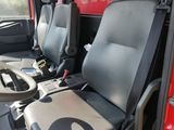 two seats in the back of a truck with a steering wheel