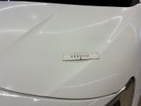 a close up of a white car with a sticker on it