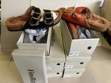 two pairs of shoes that are in boxes on the floor