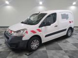 the white van is parked on a checkered floor in the garage